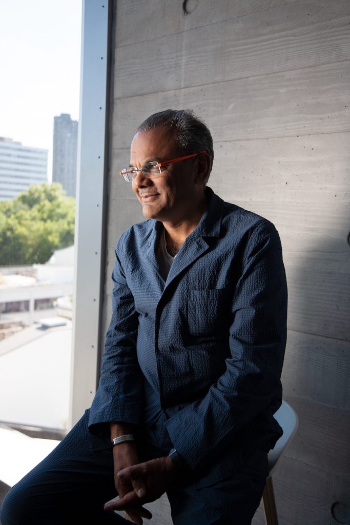 Hanif Kara sitting next to a window.