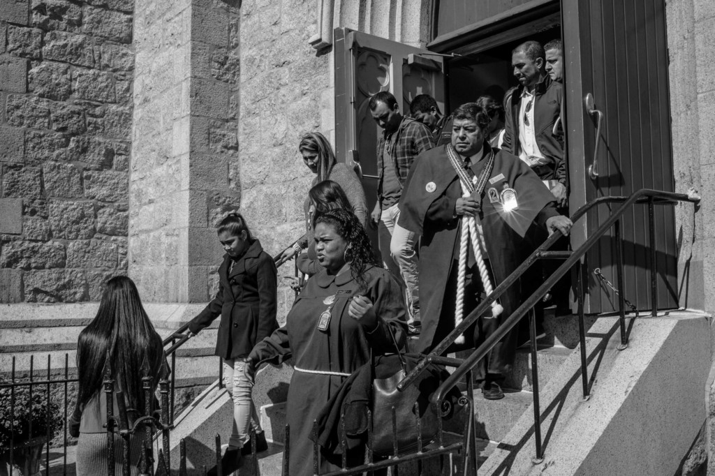 Black and white photograph of church goers exiting the building.