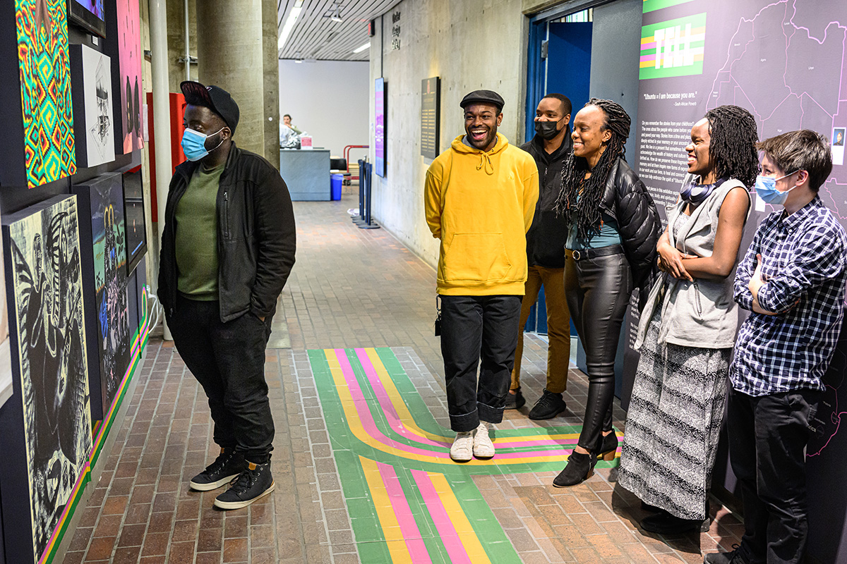 A group of people viewing and enjoying an exhibit of artwork.