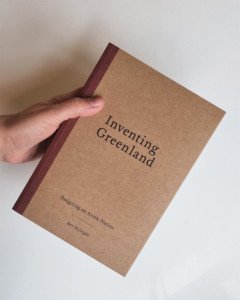 Cover of the book 'Inventing Greenland" held by hand