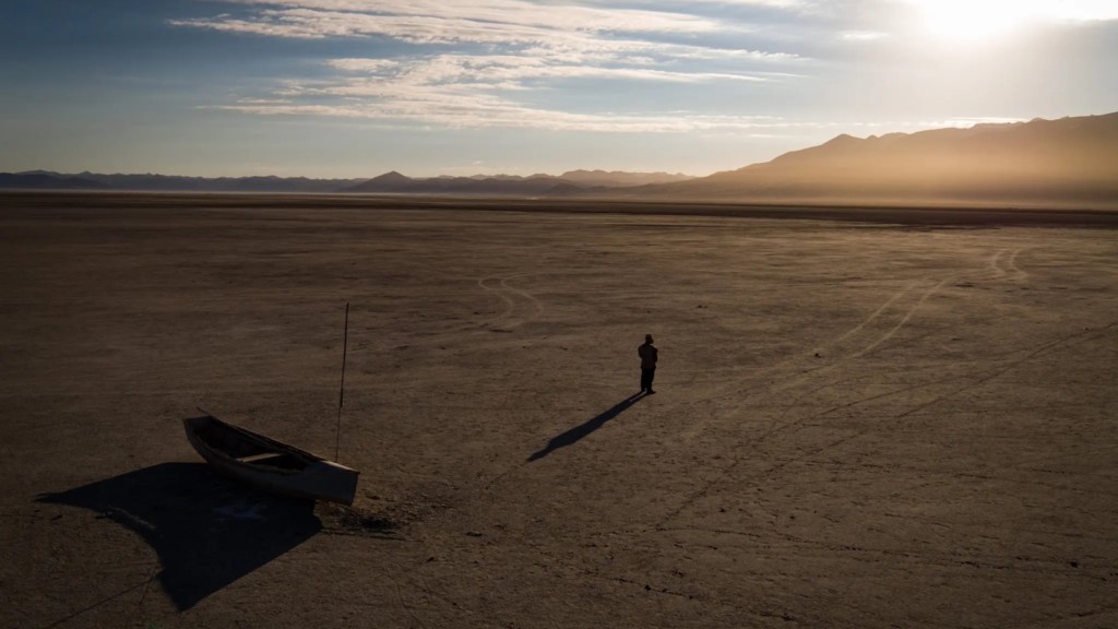 Indigenous leader standing alone in desert
