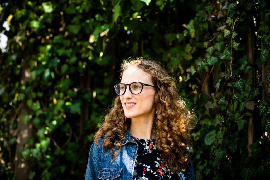 Headshot of Nina Sayles in front of ivy.