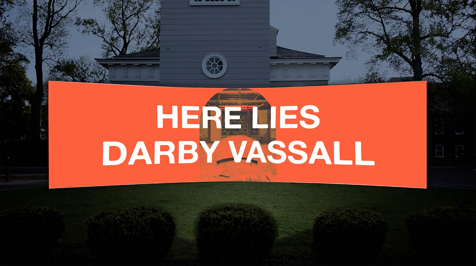 visualization of curved wall with video screen that reads "HERE LIES DERBY VASSALL"