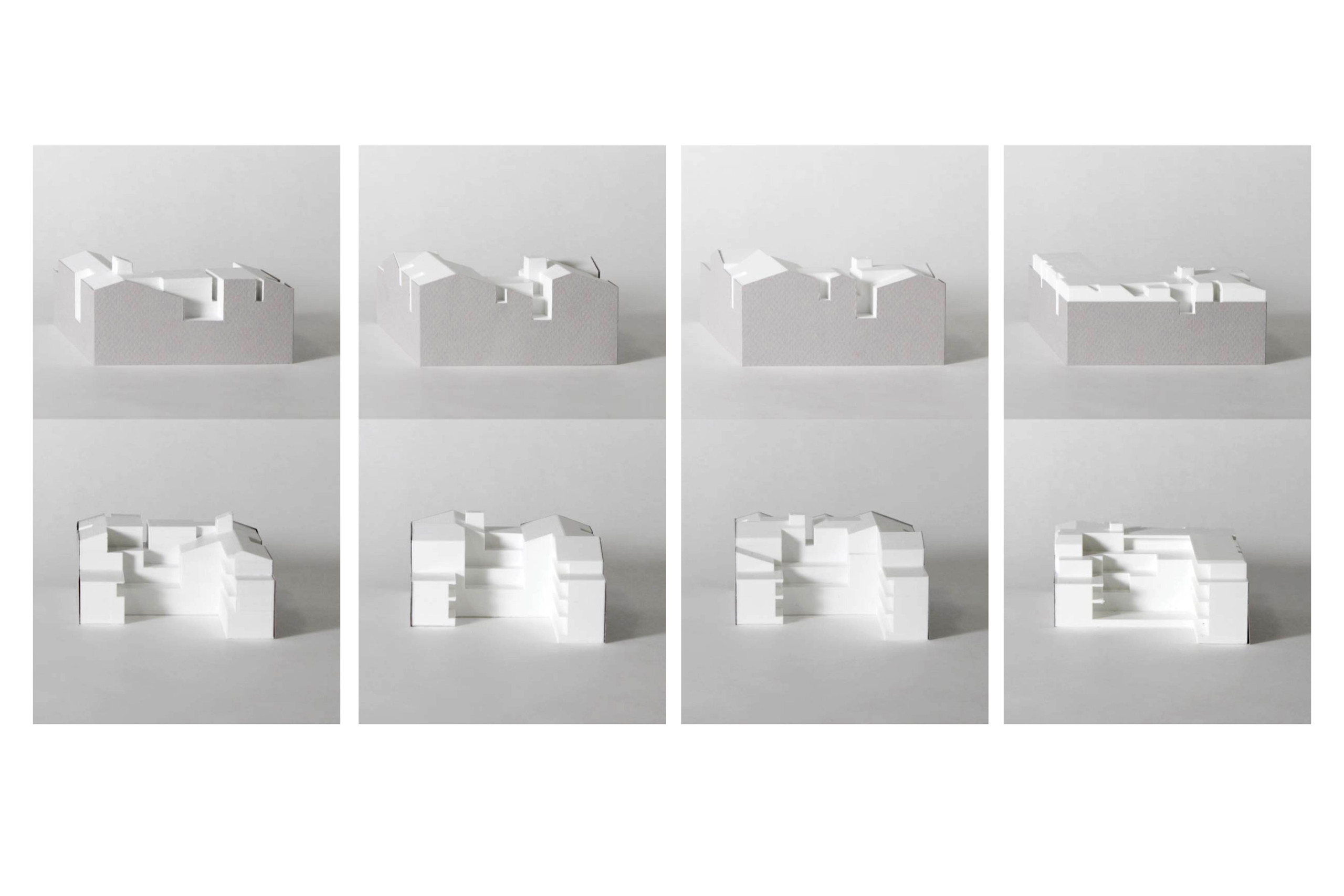 A series of white and grey massing models with interior spaces carved out.