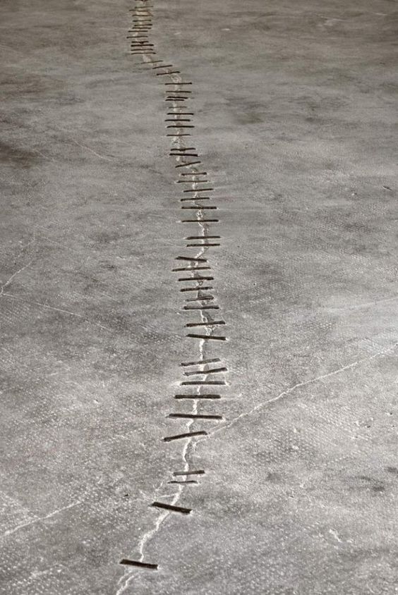 A concrete floor patched by pieces of metal