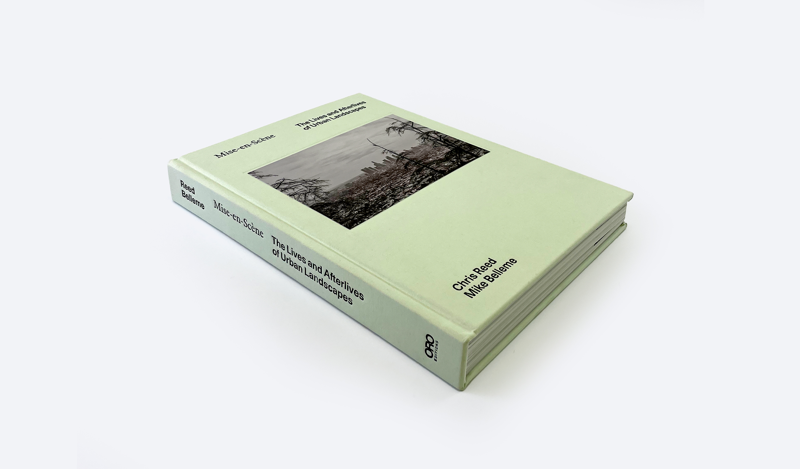 photo of light green book with black and white photograph on the front