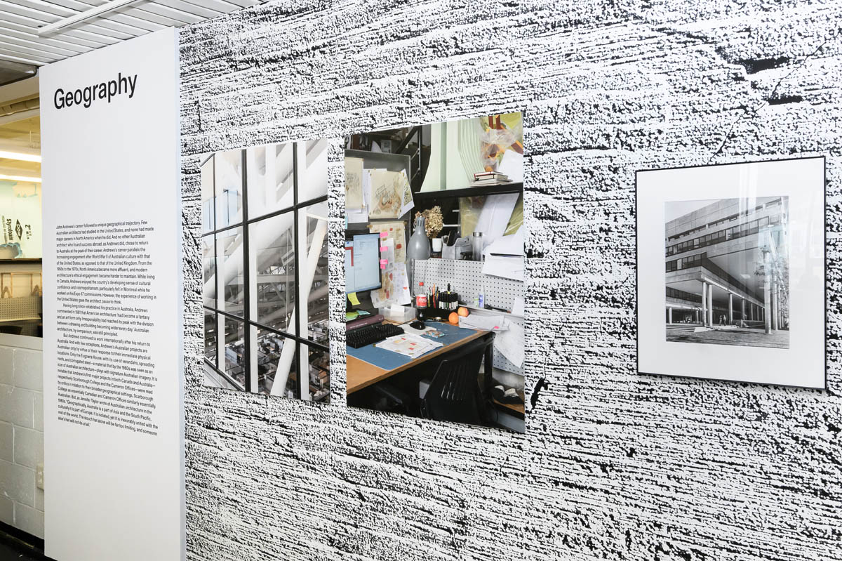 A large text panel. A diptych of new interior views of Gund Hall. A single framed photos of the exterior of Gund Hall in the 1970's. All against a stylized cement textured background.