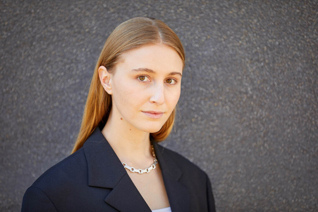 Headshot of Dutra Brown against grey background