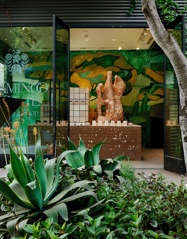 View of wellness installation, frames by bright green foliage. 