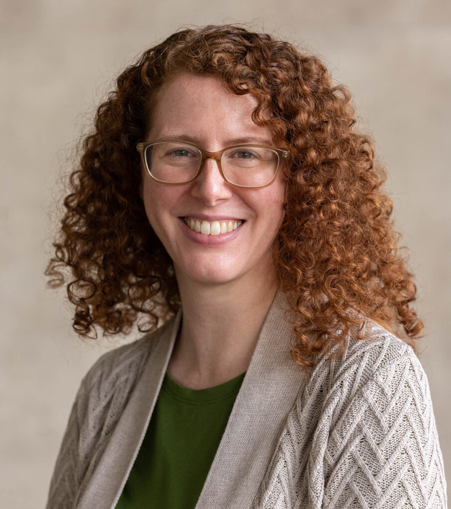 Headshot of caucasian female wearing glasses and smiling