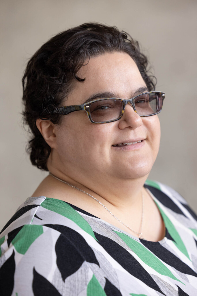 Photo of a caucasian female in glasses looking at the camera