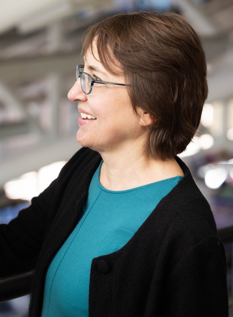 Photo of a caucasian female looking to the side smiling