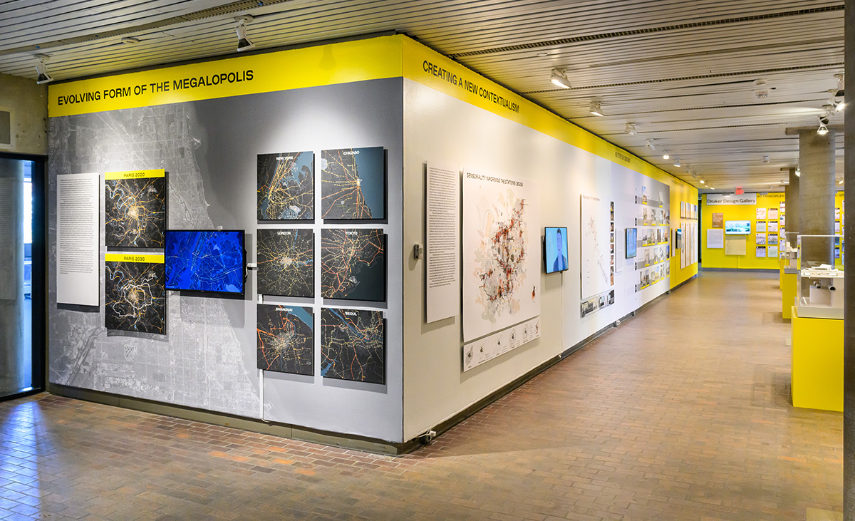 A view of the exhibit showing a lobby with maps and video screens on the walls.