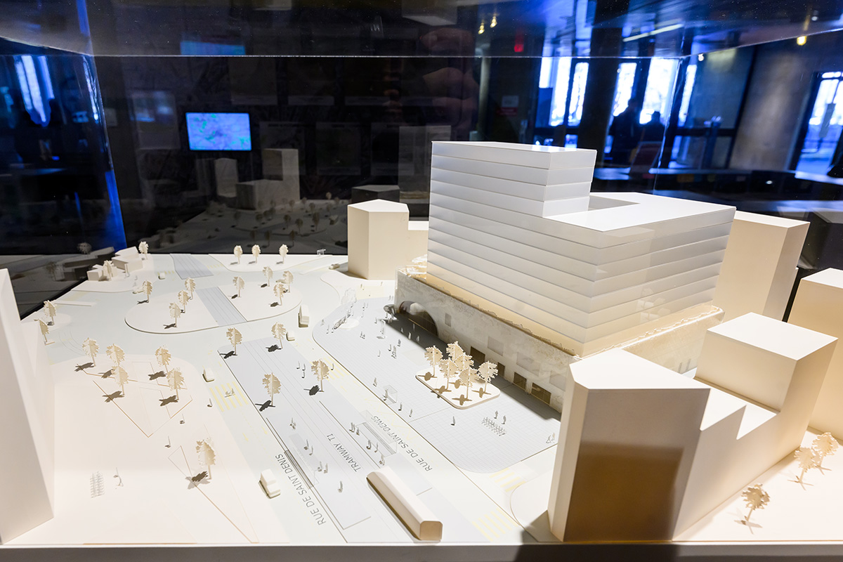 Architectural model of a train station exterior and the surrounding buildings and streets.
