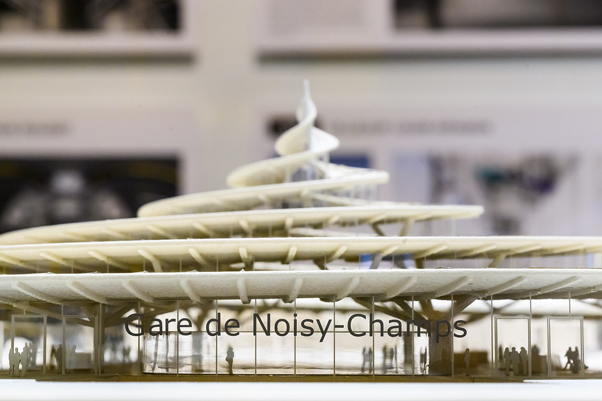 A detail of an architectural model showing a train station with a spiral corkscrew shaped roof.