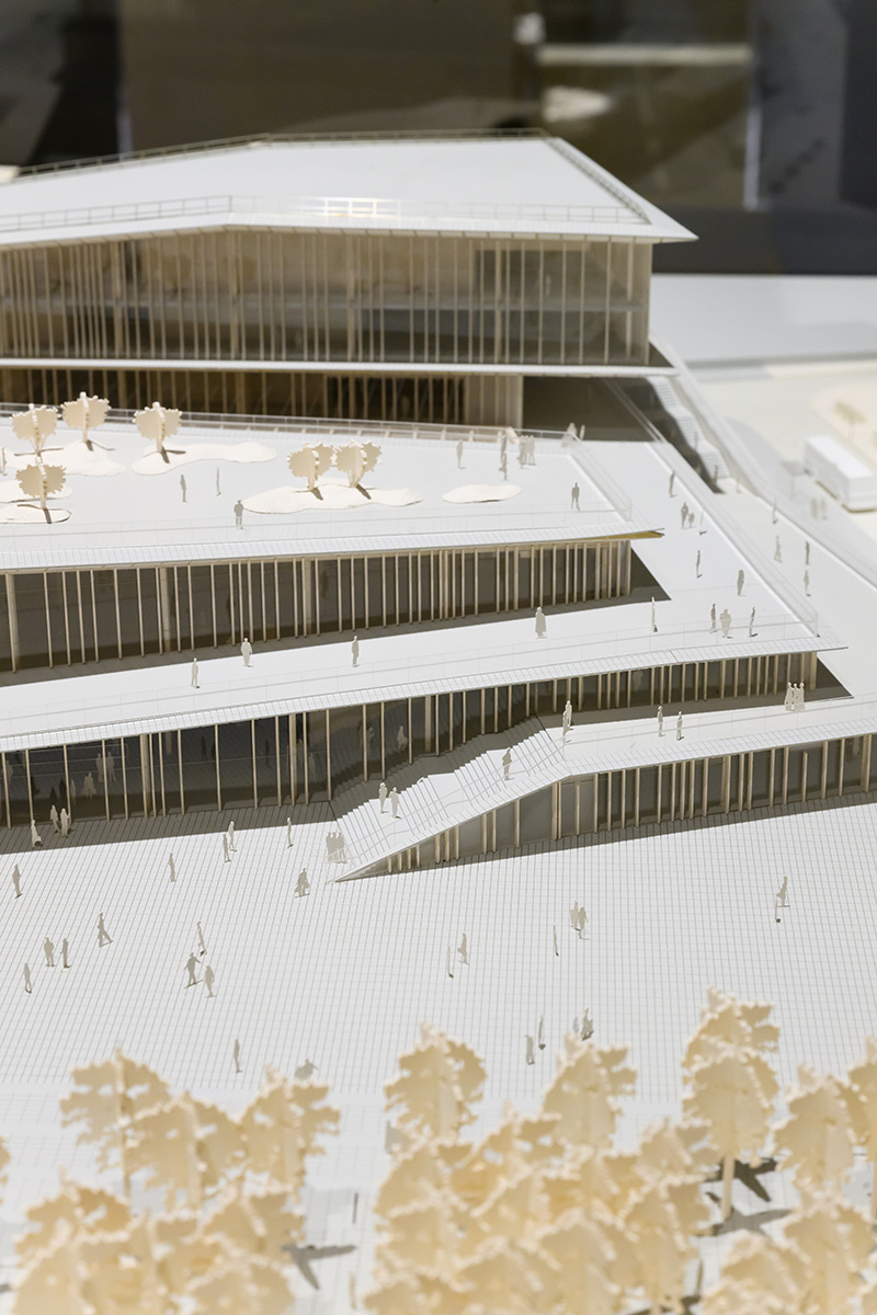 Detail of an architectural model of a multi-story building with multiple terraces for people and landscaping.