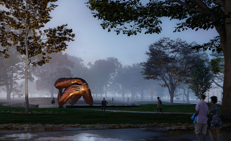 large sculpture of hands embracing