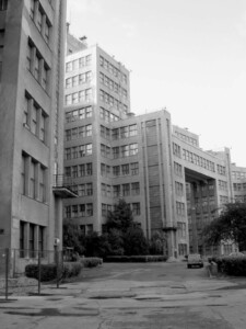 View of building with rows of glass windows; black and white