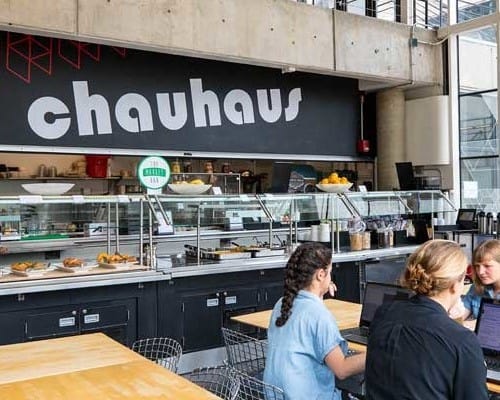 Students sit at a table in Chauhaus.