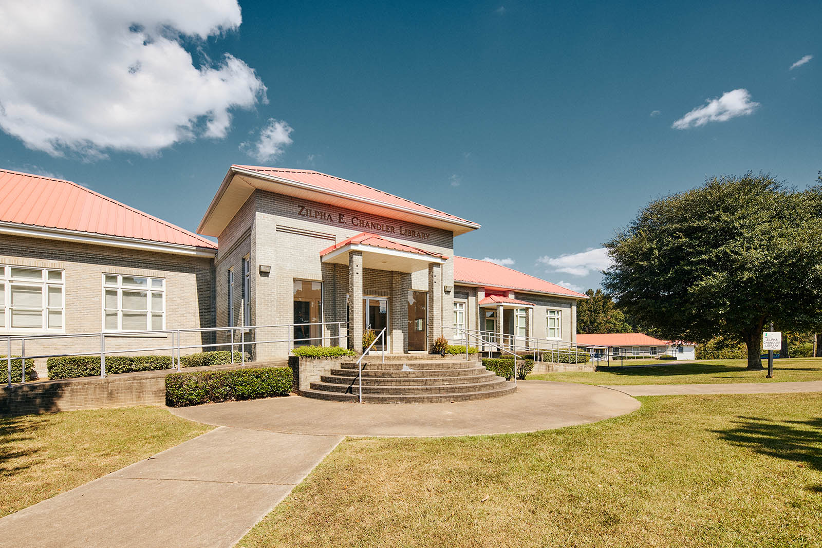 Photos of a brick building with red roof