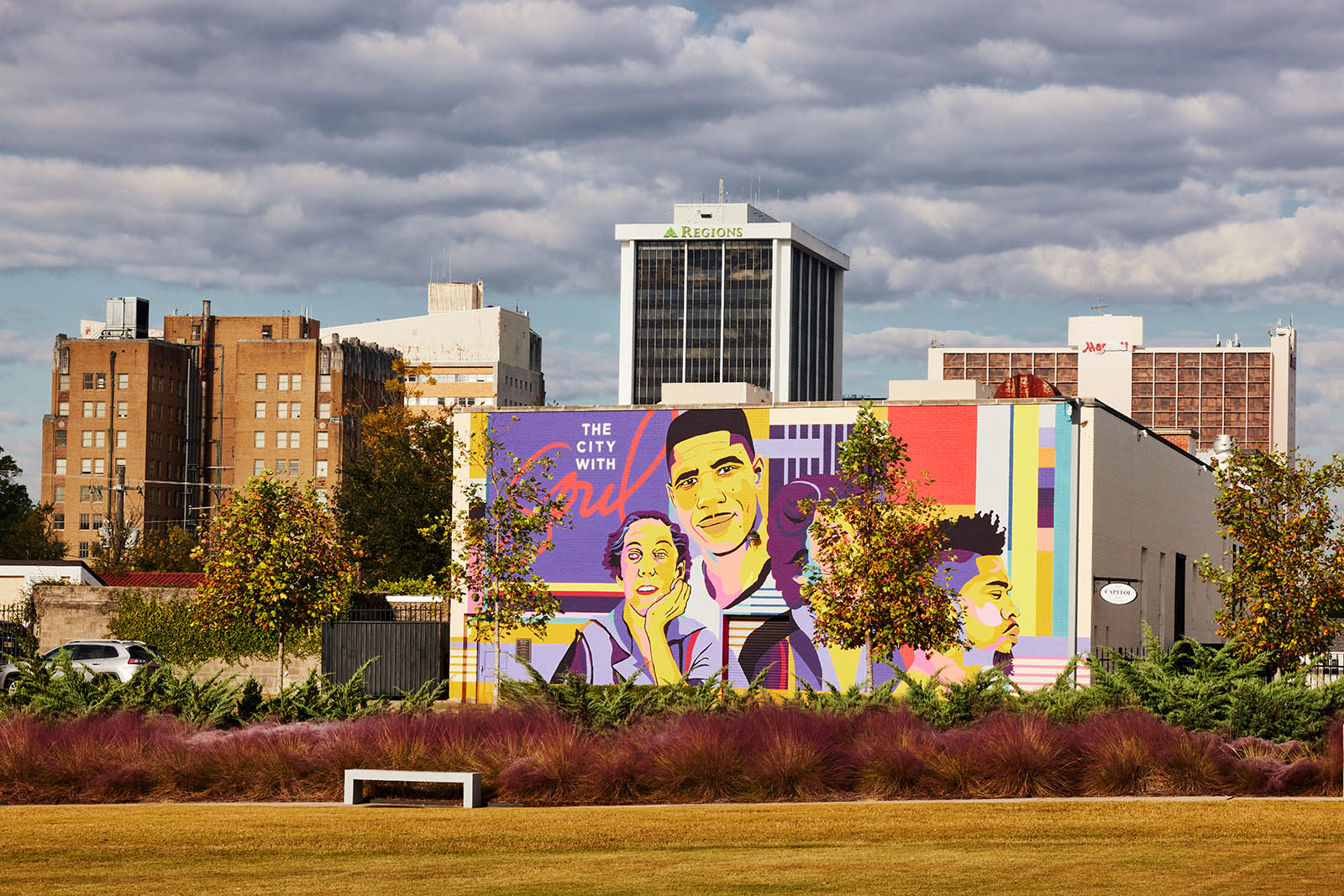 Photo of a mural with four faces painted.