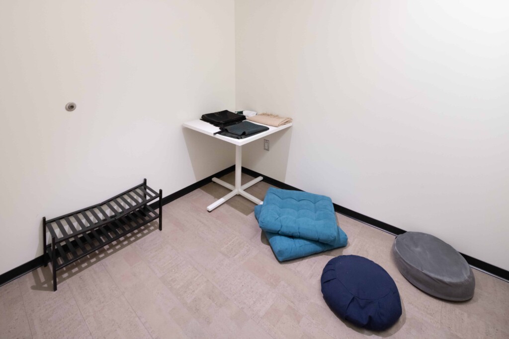 The interfaith prayer and meditation room with cushions and a table. 