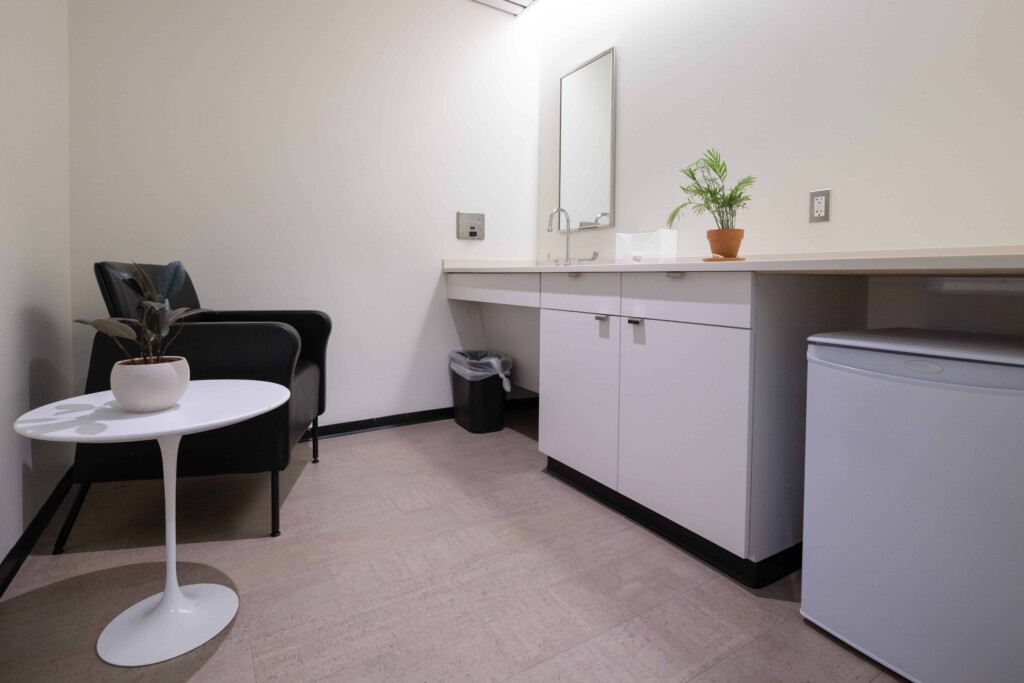 The lactation room with fridge, sink, and soft seating.