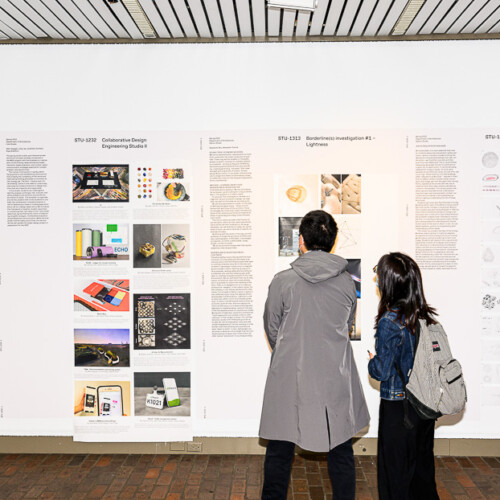 two people looking at an exhibition of various materials in tall panels