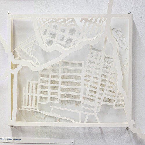 detail of a model made from cut paper hung on a wall