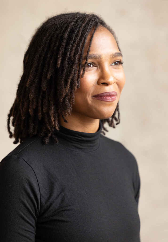 Photo of African American female looking off camera smiling