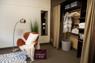 Interior image of a closet and chair in student housing.