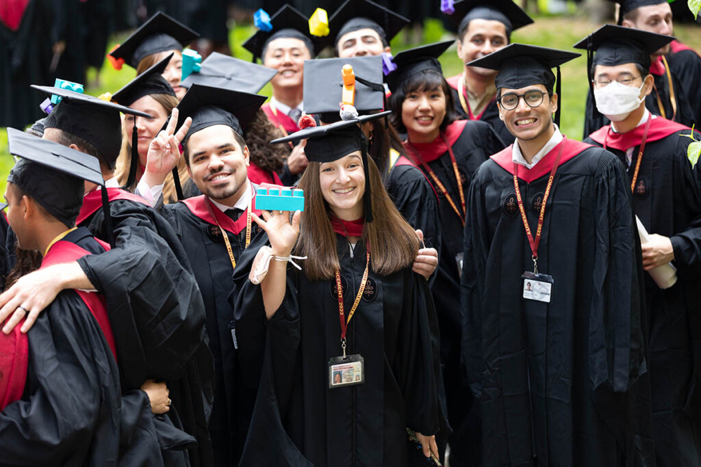 A photograph of GSD students in caps and gowns at commencement.