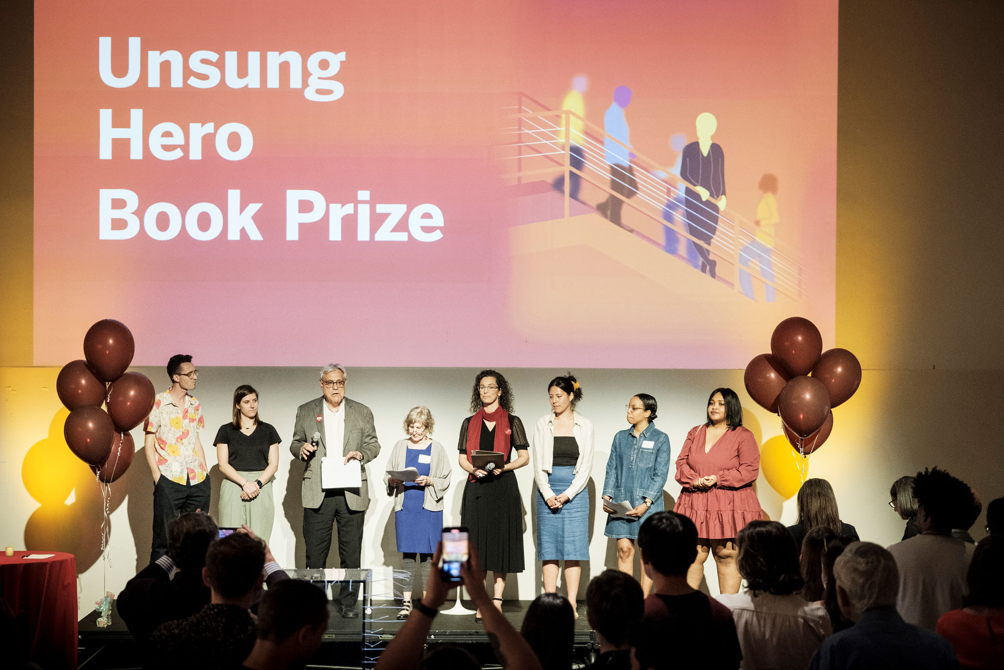 Unsung hero winners celebrating on stage at the ceremony