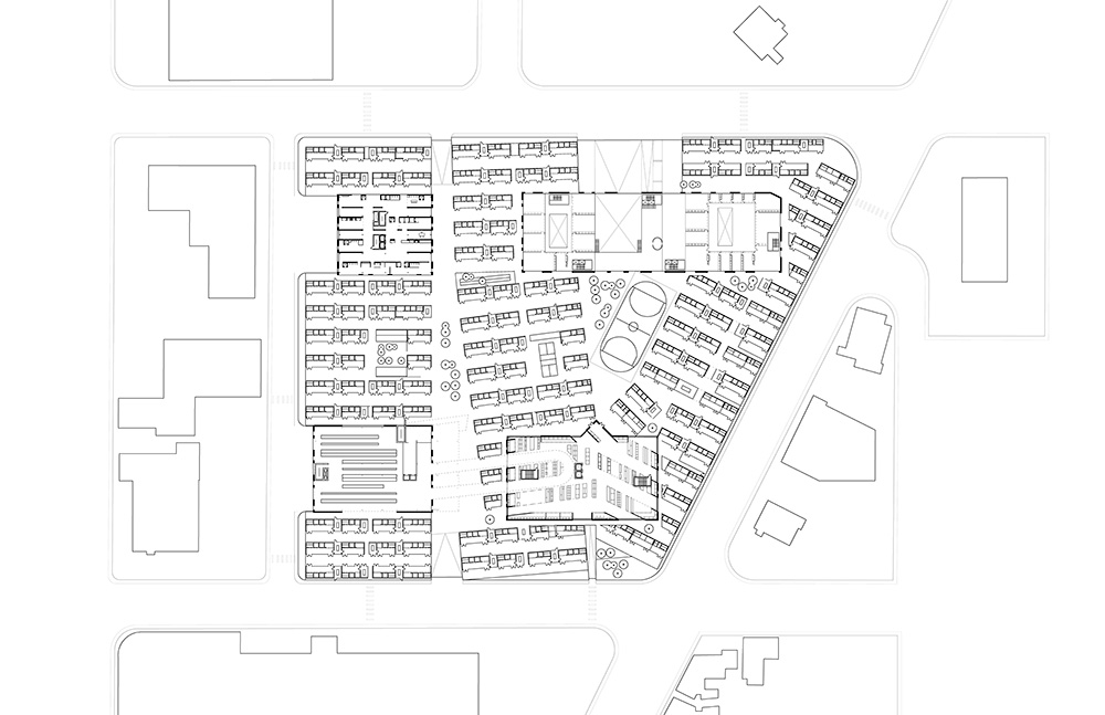 An architectural plan for a housing project that features many small residential units arranged in rows around large office structures and big box stores.
