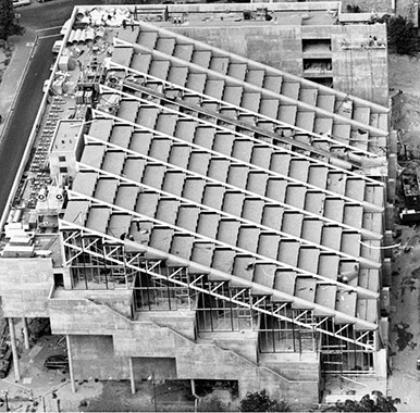 An aerial view of Gund Hall showing the distinctive sloped roof covering the trays area of the building.