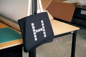 A tote bag with the H GSD Logo