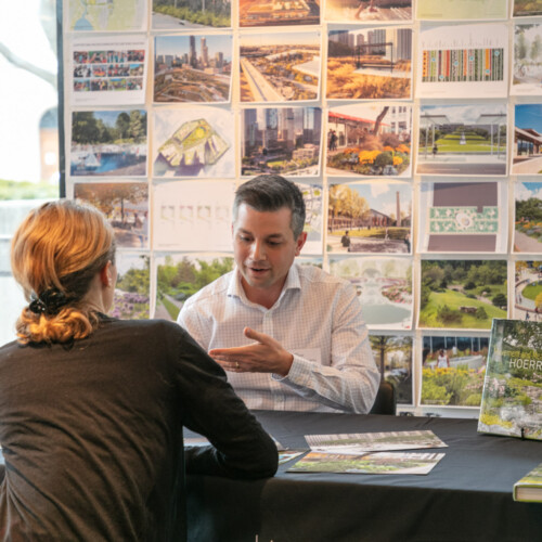 Photo of employer talking to student at job fair