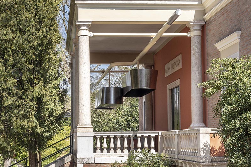 An exterior of the Great Britain pavilion at the Venice Architecture Biennale showing a sculpture by Jayden Ali hanging over the entrance.