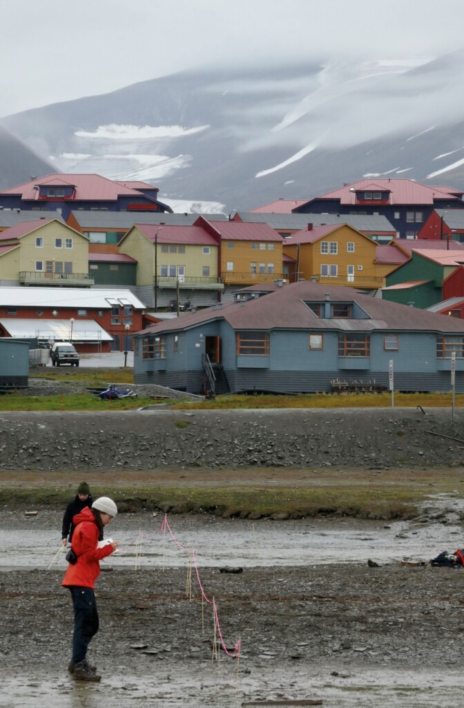 colorful houses and building with person in red jacket standing in front
