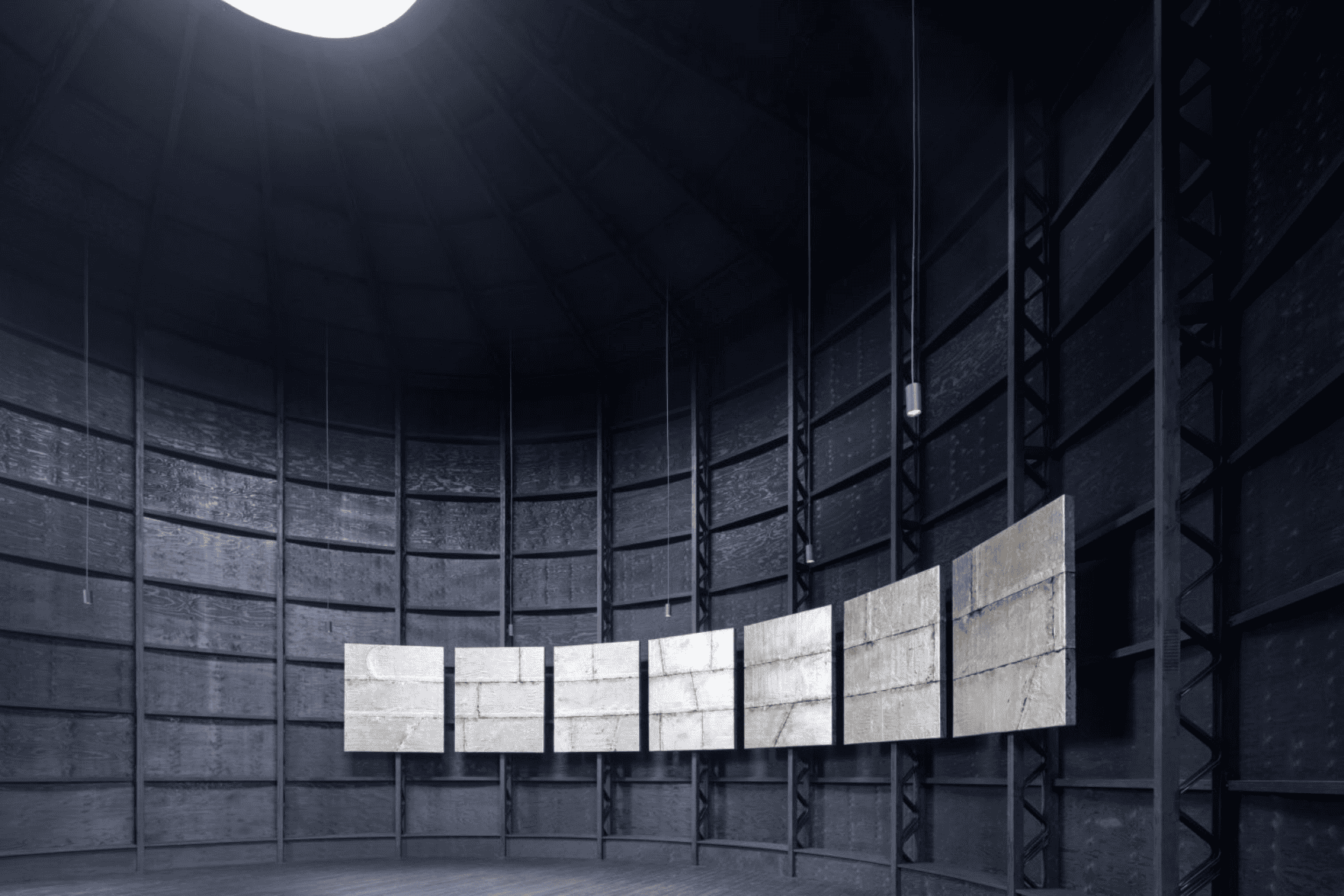 Taupe colored panels against a paneled black room with a light overhead.