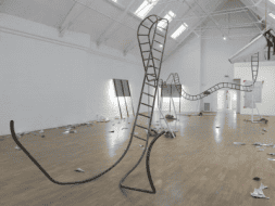 Image of twisting stairs in an open white loft space.