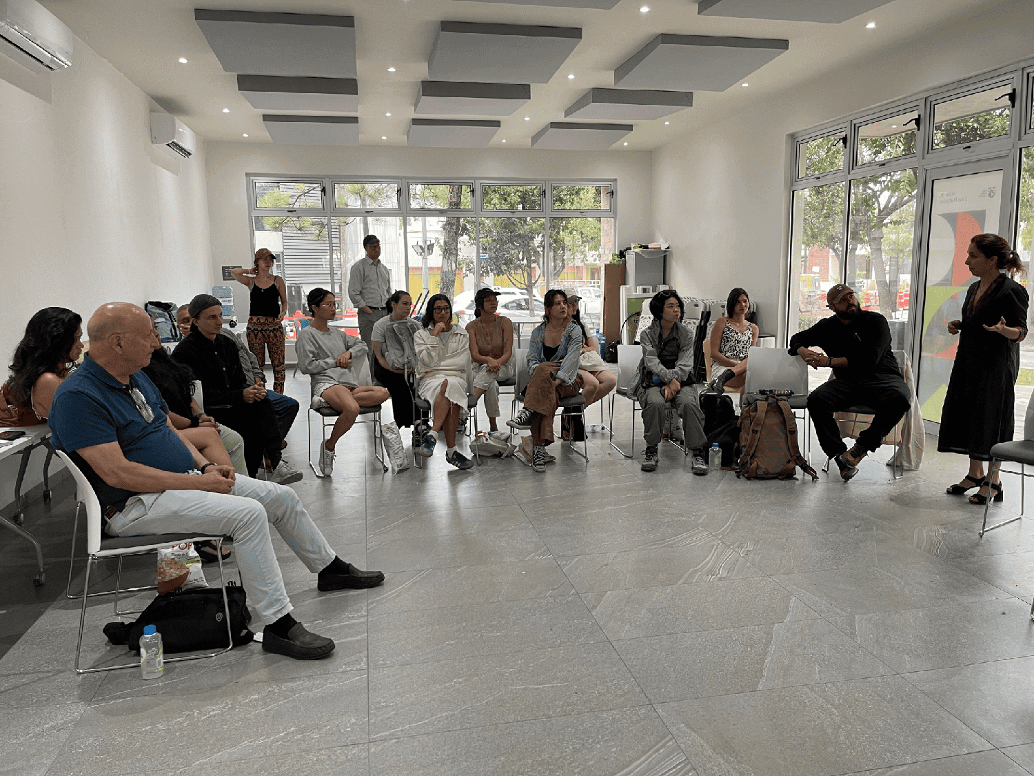 People sitting in chairs in a building.