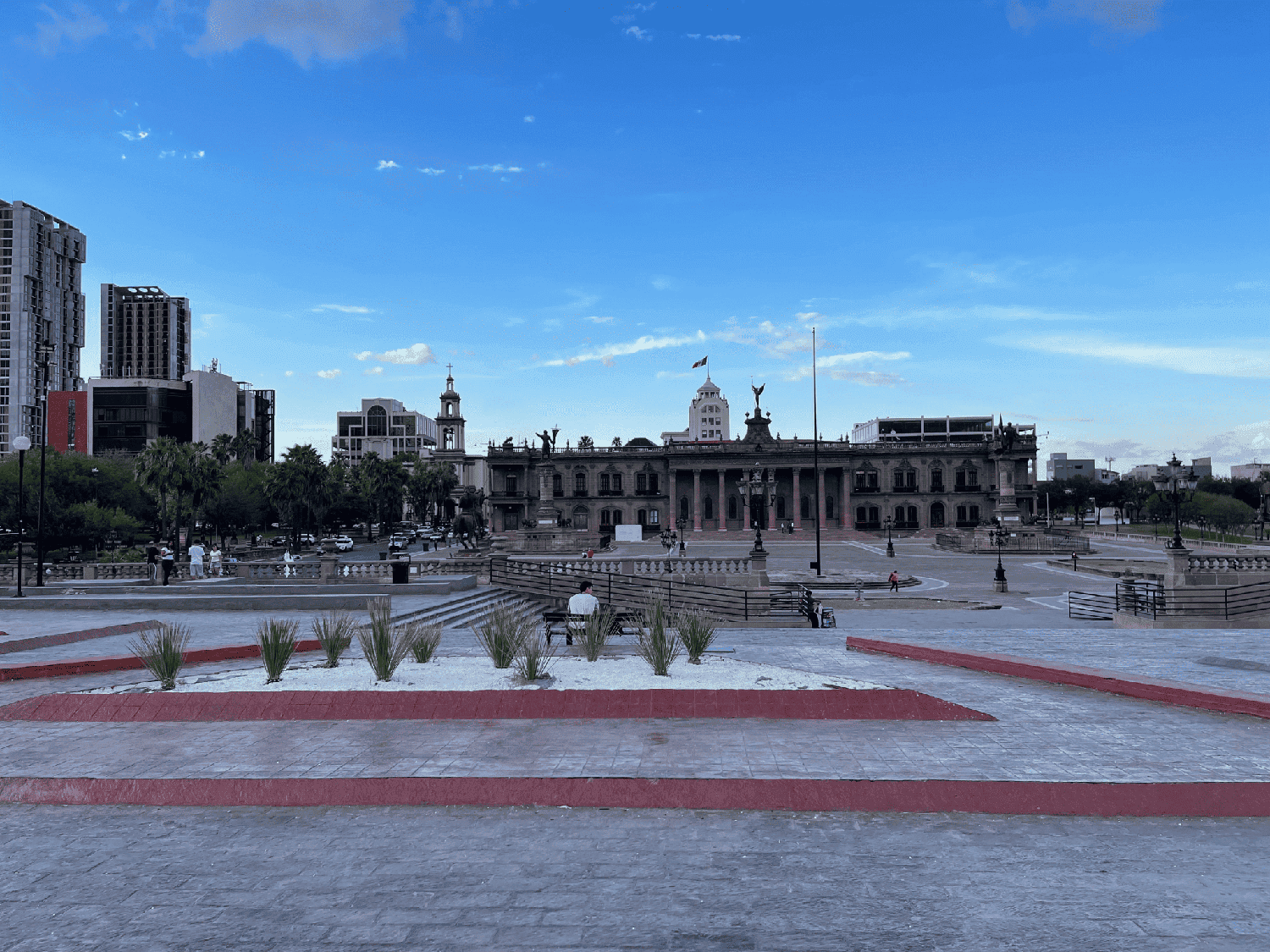 A large open plaza with buildings at the far end.