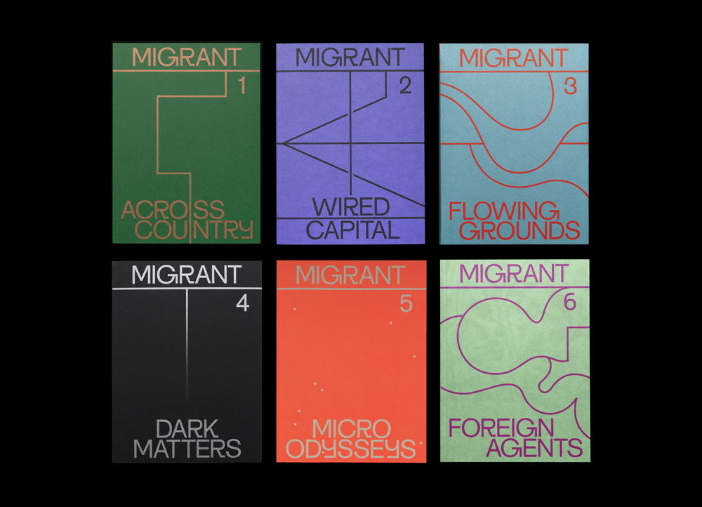 A photograph depicting the covers of six issues of Migrant Journal. The covers are arranged in two rows of three. On each cover is a different geometric design resembling a diagram. Each cover also has a title and a unique color such as purple, red, green, blue, and black.