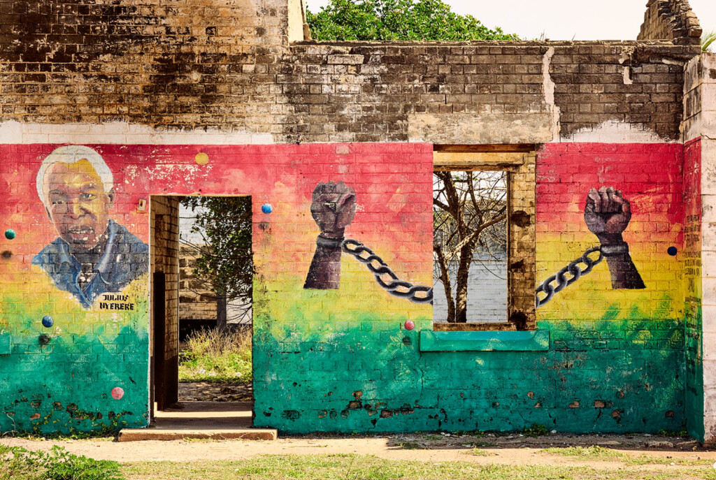 Photos of building ruins with mural depicting chained hands and a picture of a black man