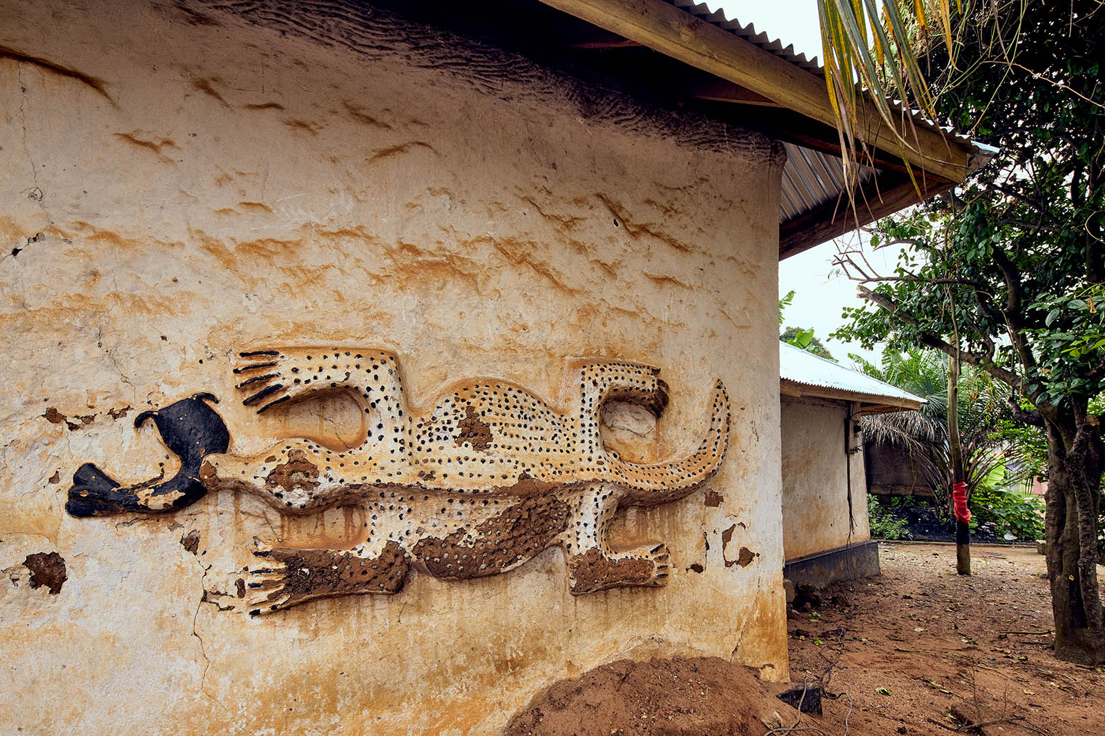A crocodile bas-relief on a white washed building wall