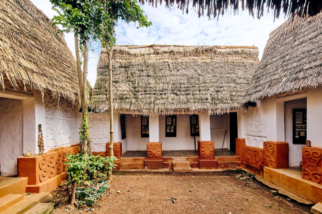 Photo of thatched roofed structured forming a courtyard.