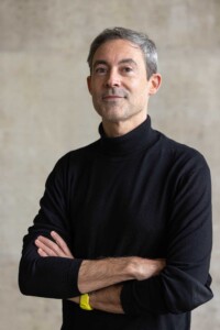 Portrait of Pablo Perez-Ramos against a slate gray backdrop.