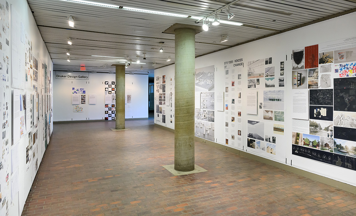 A view of the exhibit in Druker Design Gallery, showing a large variety of images displayed on the walls.