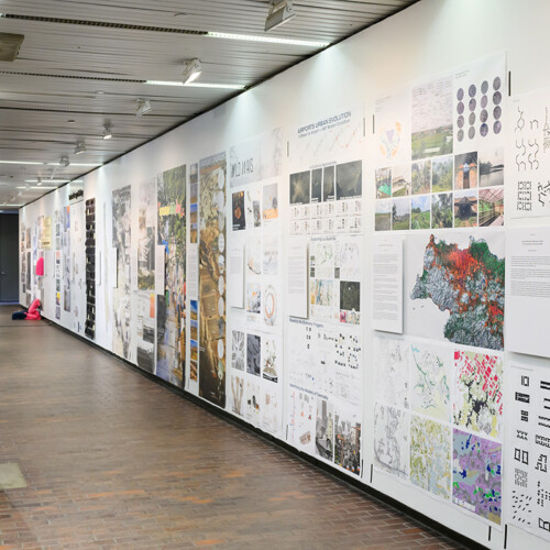 A view of the exhibit in Druker Design Gallery, showing a large variety of images displayed on the walls.